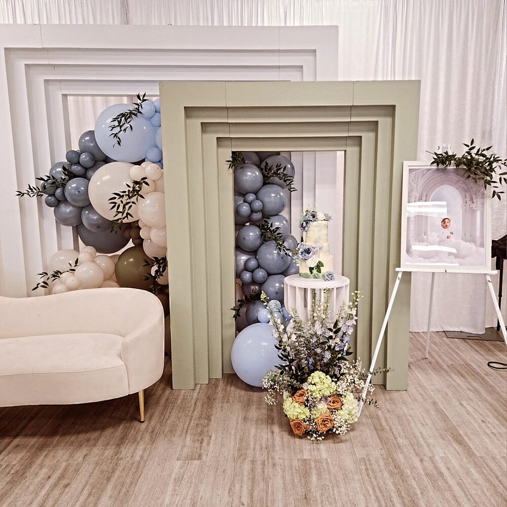 Sage and dusty blue frame arch with balloons, baptism cake