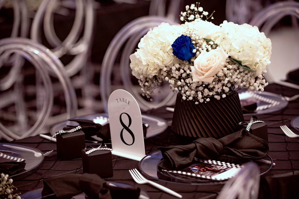 Black, white, and blue rose centerpiece at a race-themed party