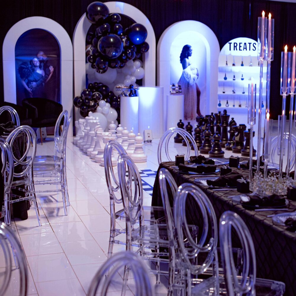 Black and blue chess-themed lounge with a treats display