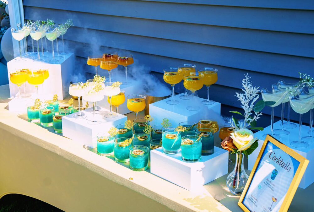 Cocktail bar styled in blue, orange, and white with signature drinks