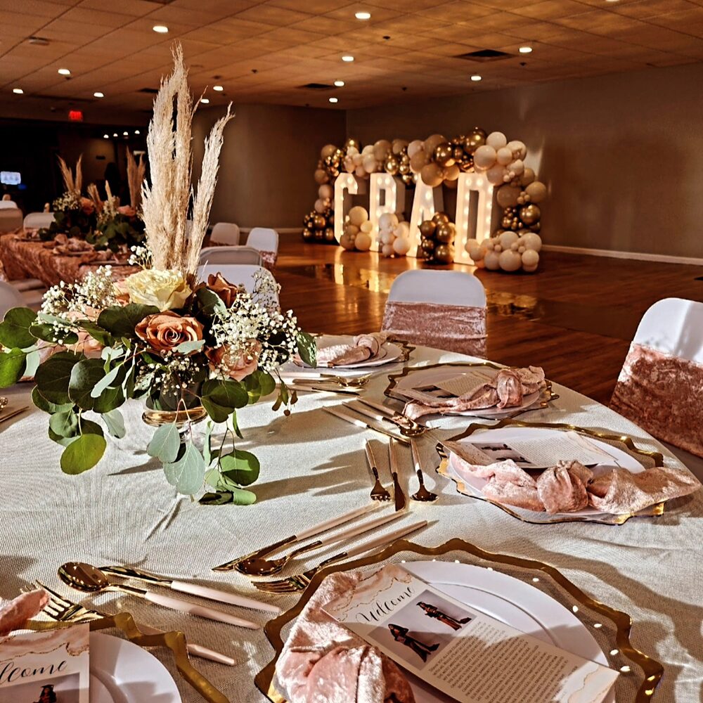 Rose gold marquee letters and balloon arch at a graduation gala