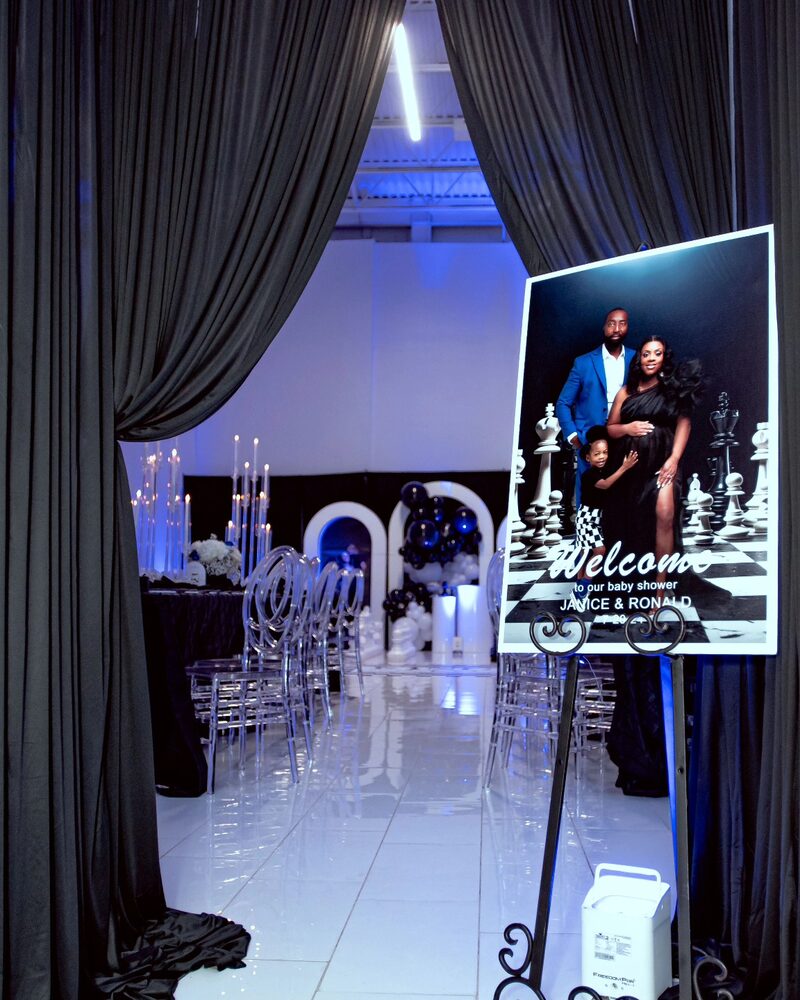 Black and white welcome sign at a chess-themed baby shower